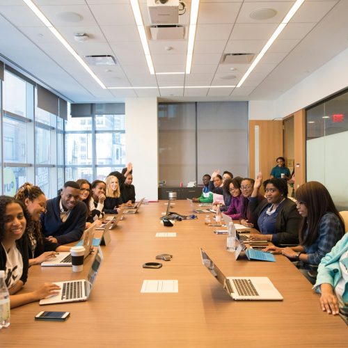 A diverse group of professionals engaging in a productive meeting around a conference table.